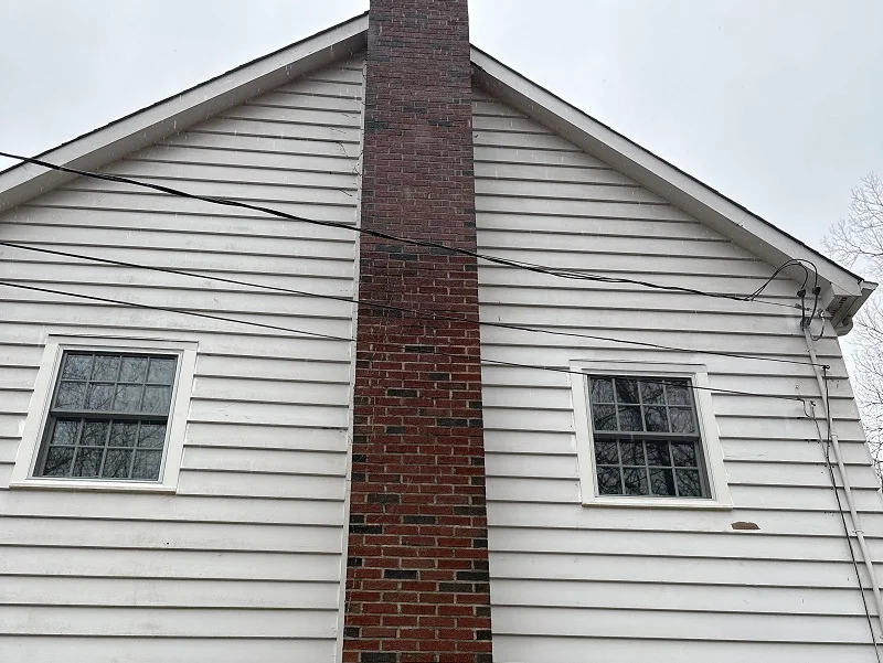 Pella Lifestyles double hungs with SDL authentic grids on the side of a fireplace